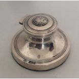 A circular silver capstan shaped inkwell. Chester.