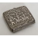 A heavy Chinese silver cigarette case decorated wi