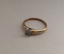 A 9 carat four stone princess cut ring. Approx. 2