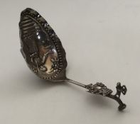 A small Dutch silver preserve spoon decorated with