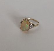 A 9 carat opal single stone ring. Approx. 3 grams.