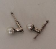 A pair of unusual gold and pearl ear studs. Approx
