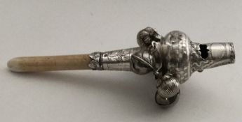 A good quality silver rattle decorated with wriggl