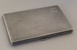 An engine turned silver cigarette box with cut cor