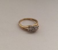 An 18 carat gold diamond cluster ring. Approx. 3.4