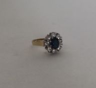 An 18 carat gold sapphire and diamond cluster ring