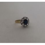 An 18 carat gold sapphire and diamond cluster ring