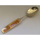 A stylish Danish silver and enamel spoon with flor