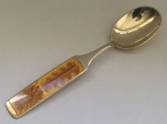 A stylish Danish silver and enamel spoon with flor