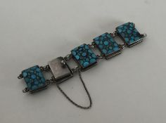 A stylish silver and turquoise panel bracelet. App
