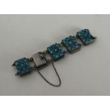 A stylish silver and turquoise panel bracelet. App