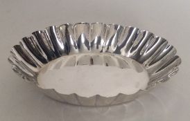 A silver bonbon dish with crimped rim. London 1890