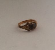 A small Antique gold mourning ring with scroll dec