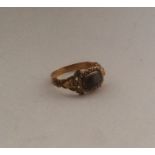 A small Antique gold mourning ring with scroll dec