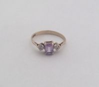 An amethyst and gold three stone ring. Approx. 1.5