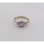An amethyst and gold three stone ring. Approx. 1.5