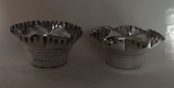 A matched pair of heavy planters with crimped rims,