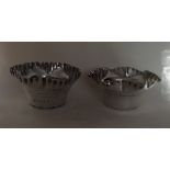 A matched pair of heavy planters with crimped rims,