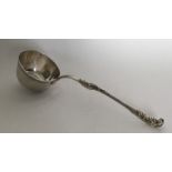 A Continental silver ladle with scroll handle. Pun