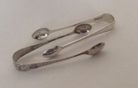 Two pairs of modern cast silver sugar tongs. Appro