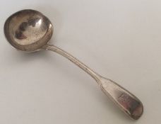 A fiddle and thread pattern silver sauce ladle. Lo