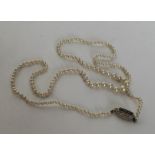 A graduated imitation seed pearl necklace with sapphire conc