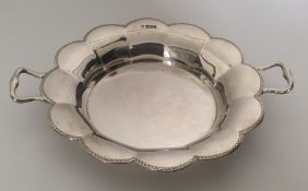 An Edwardian silver two handled basket with bright