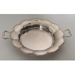 An Edwardian silver two handled basket with bright