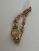 A lady's 18 carat wristwatch on 9 carat strap. App