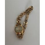 A lady's 18 carat wristwatch on 9 carat strap. App