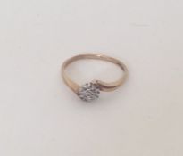 A small diamond cluster ring set in 9 carat. Appro