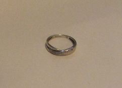 A 9 carat diamond crossover half eternity ring. Ap