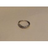 A 9 carat diamond crossover half eternity ring. Ap