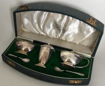 A cased silver three piece cruet. London. By Golds
