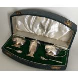 A cased silver three piece cruet. London. By Golds