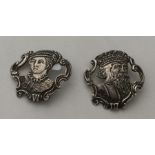A pair of stylish silver buttons in the form of a