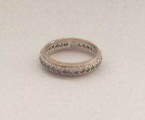 A 9 carat garnet mounted eternity ring. Approx. 3