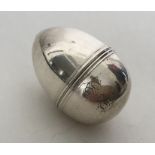 A large silver nutmeg grater in the form of an egg