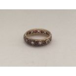 A 9 carat garnet mounted eternity ring. Approx. 3