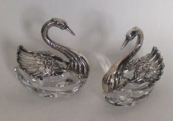 A pair of silver and glass figures of swans. Appro