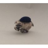 A novelty miniature silver pin cushion in the form