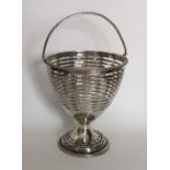 A Georgian silver swing handled basket with ball d