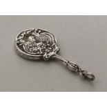 A miniature silver mirror mounted with a lady. App