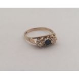 A diamond and sapphire three stone ring. Approx. 2