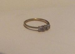 A 9 carat diamond three stone ring in claw mount.