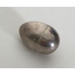 A small egg shaped silver nutmeg grater with steel