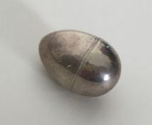 A small egg shaped silver nutmeg grater with steel