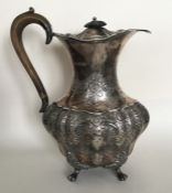 A good quality Edwardian silver water jug embossed