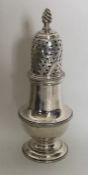 A Georgian silver baluster shaped caster with twis