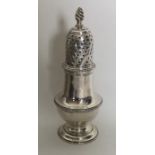 A Georgian silver baluster shaped caster with twis